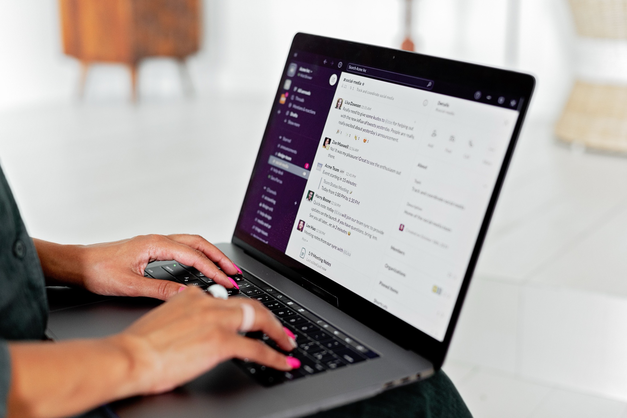Close-up of hands using a customer messaging platform on a laptop